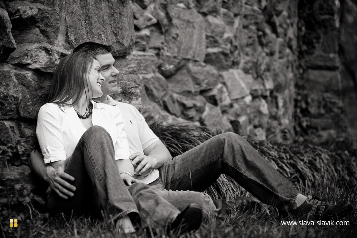 By the wall in the grass