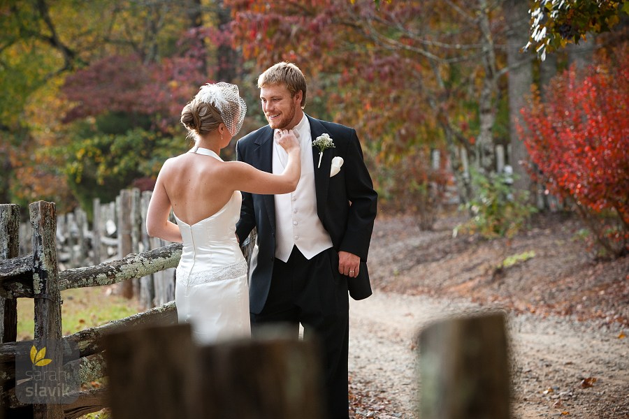 Bride groom near farm fence