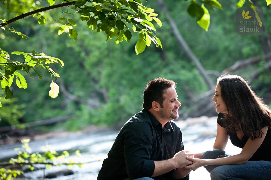 Engaged couple on a river